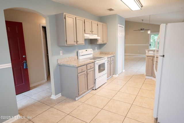 3013 Wavering Ln, Middleburg, FL 32068 - kitchen with white appliances, light countertops, ceiling fan, arched walkways, and light tile patterned floors