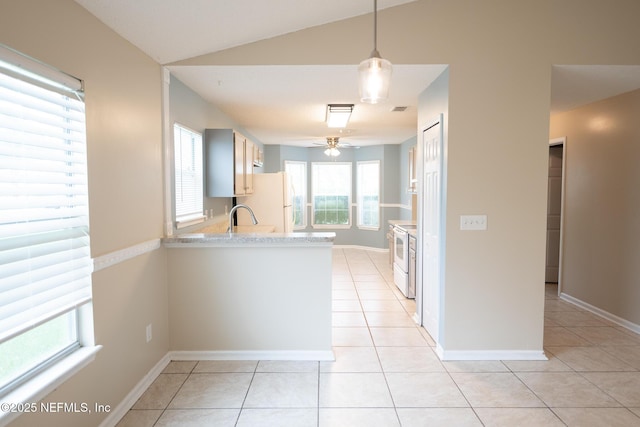 3013 Wavering Ln, Middleburg, FL 32068 - kitchen featuring light countertops, white appliances, light tile patterned flooring, a ceiling fan, and lofted ceiling
