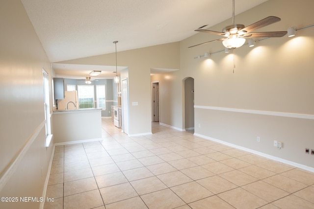 3013 Wavering Ln, Middleburg, FL 32068 - unfurnished room with a ceiling fan, arched walkways, light tile patterned floors, and high vaulted ceiling