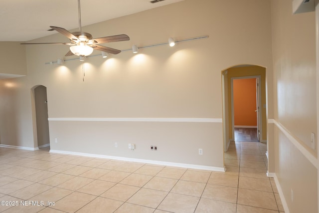 3013 Wavering Ln, Middleburg, FL 32068 - spare room with arched walkways, light tile patterned floors, a ceiling fan, and a towering ceiling