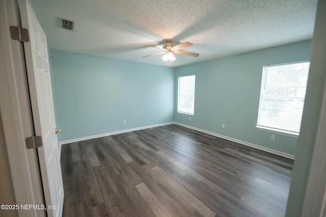 3013 Wavering Ln, Middleburg, FL 32068 - unfurnished room with a ceiling fan, dark wood-style floors, and a textured ceiling