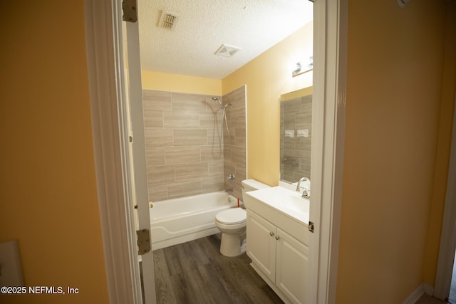 3013 Wavering Ln, Middleburg, FL 32068 - bathroom featuring vanity,  shower combination, wood finished floors, and a textured ceiling