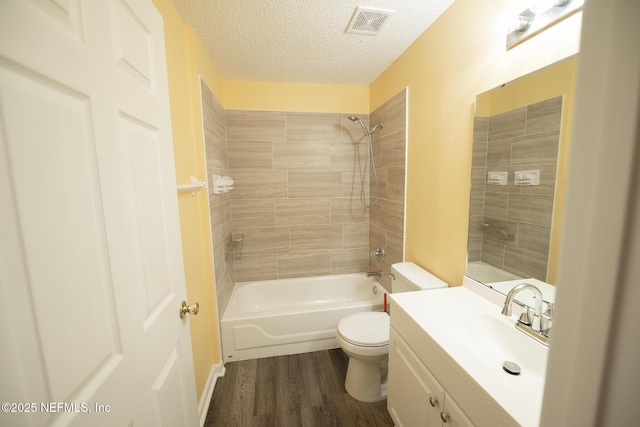 3013 Wavering Ln, Middleburg, FL 32068 - full bathroom featuring vanity, shower / tub combination, wood finished floors, and a textured ceiling