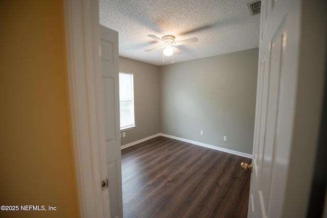 3013 Wavering Ln, Middleburg, FL 32068 - empty room featuring a ceiling fan, a textured ceiling, and dark wood-style floors