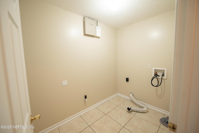 3013 Wavering Ln, Middleburg, FL 32068 - washroom with hookup for an electric dryer, a textured ceiling, washer hookup, and light tile patterned flooring