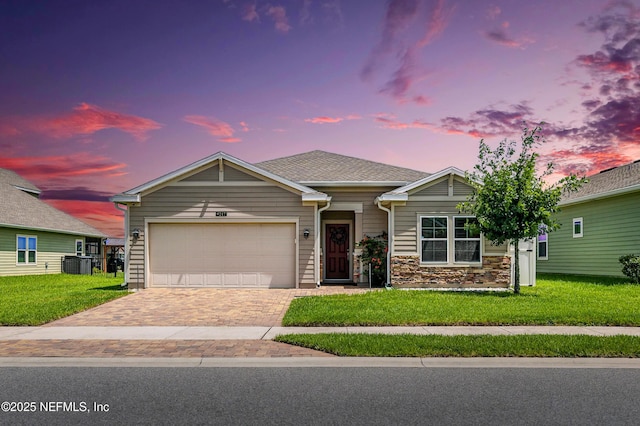9217 Gilmore Grove Way, Jacksonville, FL 32211 - ranch-style house with decorative driveway, a garage, a front lawn, and stone siding