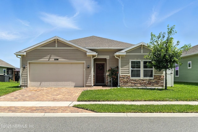 9217 Gilmore Grove Way, Jacksonville, FL 32211 - view of front of house with decorative driveway, an attached garage, and a front lawn