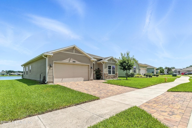 9217 Gilmore Grove Way, Jacksonville, FL 32211 - view of front of home with decorative driveway, a front yard, and an attached garage