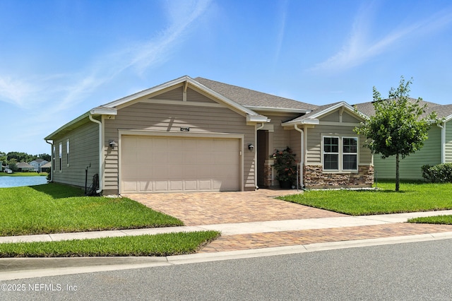 9217 Gilmore Grove Way, Jacksonville, FL 32211 - ranch-style house featuring a garage, a front yard, and decorative driveway