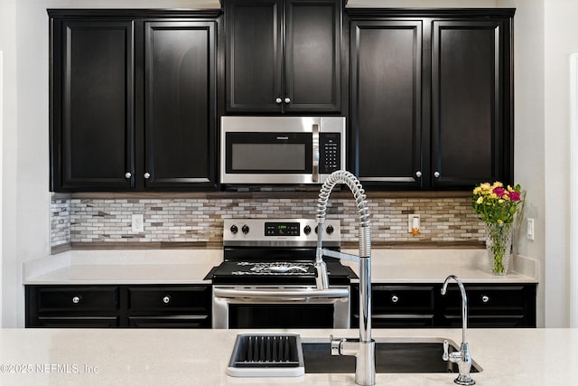 9217 Gilmore Grove Way, Jacksonville, FL 32211 - kitchen featuring stainless steel appliances, dark cabinetry, and decorative backsplash