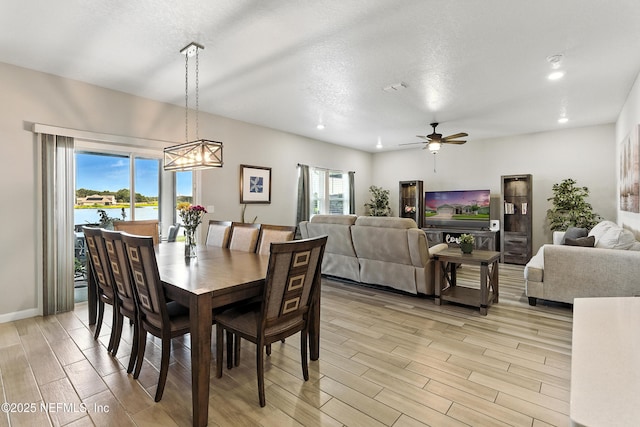 9217 Gilmore Grove Way, Jacksonville, FL 32211 - dining room with light wood-style floors, ceiling fan, recessed lighting, a water view, and a chandelier