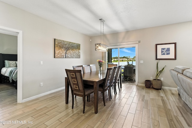 9217 Gilmore Grove Way, Jacksonville, FL 32211 - dining space featuring light wood-style flooring and a chandelier