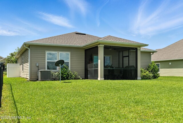 9217 Gilmore Grove Way, Jacksonville, FL 32211 - rear view of property with a sunroom, a lawn, and roof with shingles