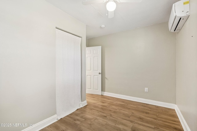 243 Ravenswood Dr, Saint Augustine, FL 32084 - unfurnished room with a wall mounted air conditioner, a ceiling fan, wood finished floors, and a smoke detector