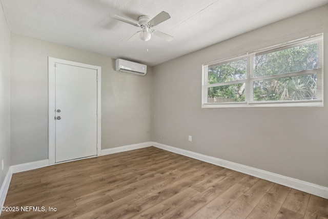 243 Ravenswood Dr, Saint Augustine, FL 32084 - unfurnished room featuring a wall unit AC, wood finished floors, and ceiling fan