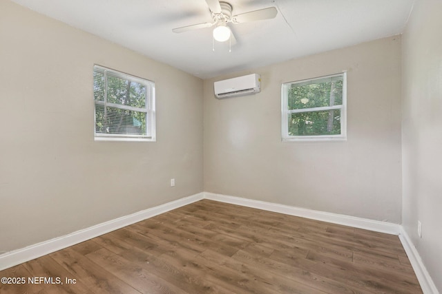 243 Ravenswood Dr, Saint Augustine, FL 32084 - spare room featuring an AC wall unit, wood finished floors, and a ceiling fan