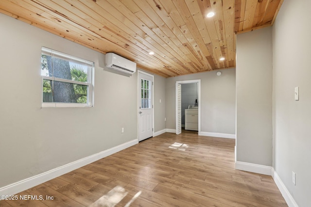 243 Ravenswood Dr, Saint Augustine, FL 32084 - unfurnished room with an AC wall unit, washer / clothes dryer, wood ceiling, light wood-type flooring, and recessed lighting