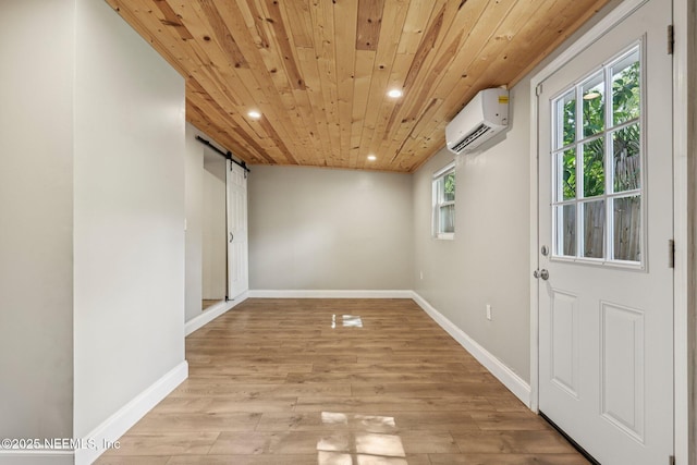 243 Ravenswood Dr, Saint Augustine, FL 32084 - unfurnished room featuring recessed lighting, a barn door, a wall mounted AC, light wood-style floors, and wood ceiling