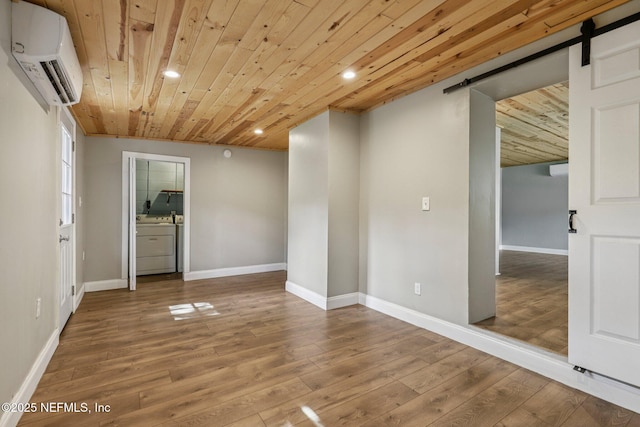243 Ravenswood Dr, Saint Augustine, FL 32084 - spare room featuring an AC wall unit, a barn door, recessed lighting, wooden ceiling, and wood finished floors