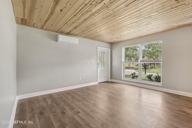 243 Ravenswood Dr, Saint Augustine, FL 32084 - spare room featuring a wall unit AC, wooden ceiling, and wood finished floors