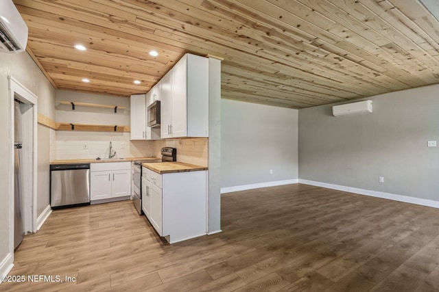 243 Ravenswood Dr, Saint Augustine, FL 32084 - kitchen featuring stainless steel appliances, wood counters, an AC wall unit, wooden ceiling, and recessed lighting
