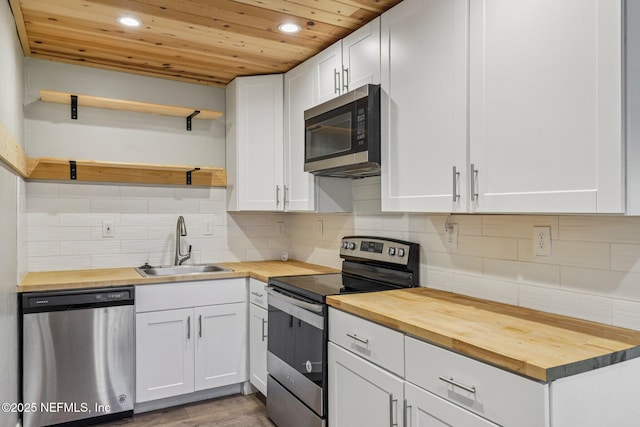 243 Ravenswood Dr, Saint Augustine, FL 32084 - kitchen with appliances with stainless steel finishes, butcher block countertops, wood ceiling, open shelves, and recessed lighting