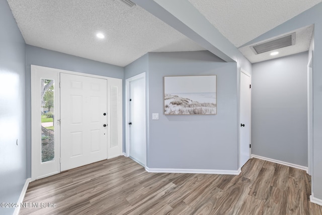 13254 Karla Cove Ln, Jacksonville, FL 32225 - foyer with wood finished floors, a textured ceiling, and recessed lighting