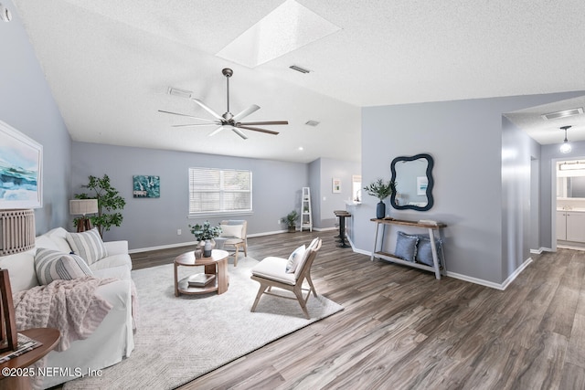 13254 Karla Cove Ln, Jacksonville, FL 32225 - living area with lofted ceiling, wood finished floors, a skylight, ceiling fan, and a textured ceiling
