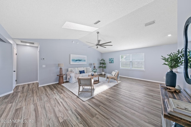 13254 Karla Cove Ln, Jacksonville, FL 32225 - living room with wood finished floors, a skylight, ceiling fan, vaulted ceiling, and a textured ceiling