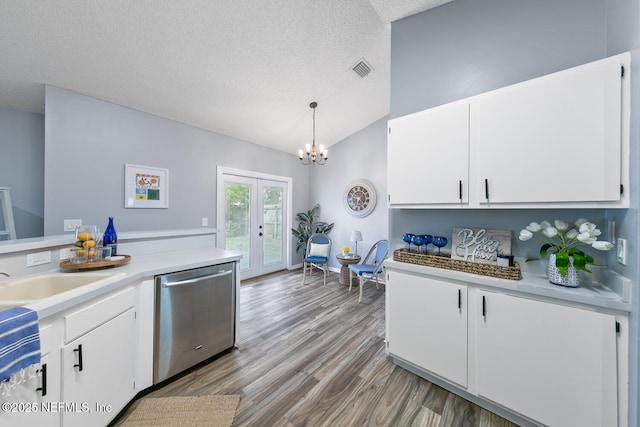 13254 Karla Cove Ln, Jacksonville, FL 32225 - kitchen with dishwasher, light countertops, a chandelier, vaulted ceiling, and white cabinets