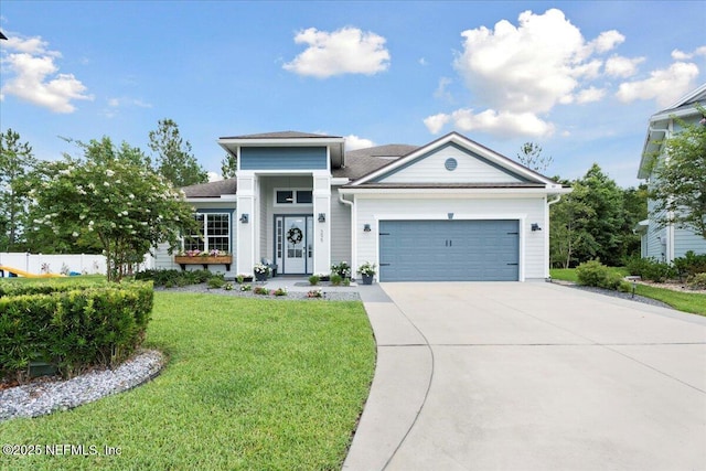 395 Jennie Lake Ct, Saint Johns, FL 32095 - view of front of house with concrete driveway, a front lawn, and an attached garage