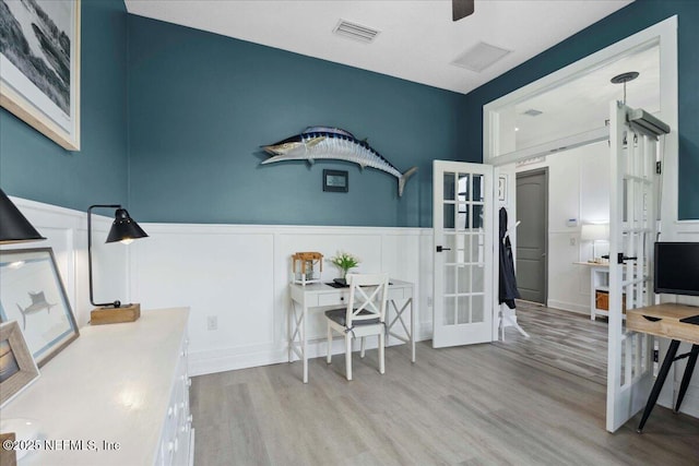 395 Jennie Lake Ct, Saint Johns, FL 32095 - home office featuring a decorative wall, french doors, wood finished floors, and wainscoting