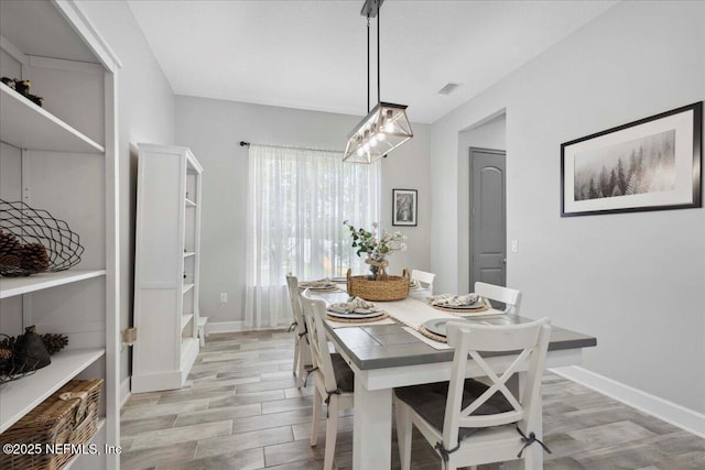 395 Jennie Lake Ct, Saint Johns, FL 32095 - dining space with light wood finished floors and a chandelier
