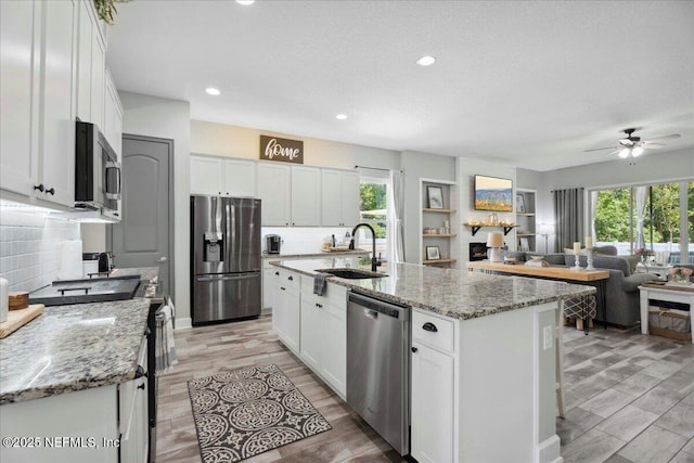 395 Jennie Lake Ct, Saint Johns, FL 32095 - kitchen featuring appliances with stainless steel finishes, ceiling fan, decorative backsplash, white cabinets, and recessed lighting
