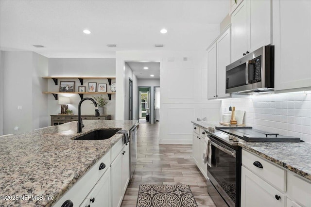 395 Jennie Lake Ct, Saint Johns, FL 32095 - kitchen featuring appliances with stainless steel finishes, decorative backsplash, white cabinets, recessed lighting, and light stone countertops