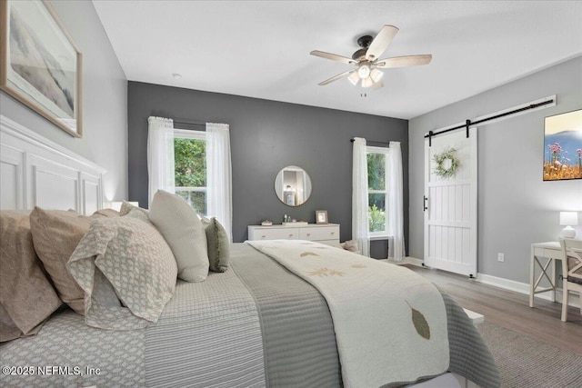 395 Jennie Lake Ct, Saint Johns, FL 32095 - bedroom featuring wood finished floors, a barn door, and ceiling fan