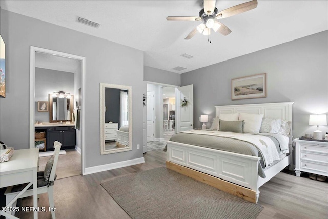 395 Jennie Lake Ct, Saint Johns, FL 32095 - bedroom with light wood-style flooring, connected bathroom, and ceiling fan