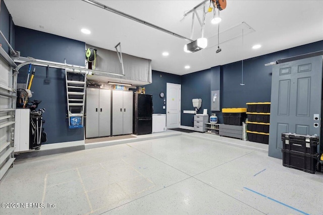 395 Jennie Lake Ct, Saint Johns, FL 32095 - garage featuring recessed lighting, electric panel, freestanding refrigerator, a garage door opener, and washer / dryer