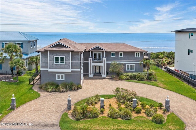 2481 S Ponte Vedra Blvd, Ponte Vedra Beach, FL 32082 - view of front of property featuring curved driveway, a water view, stucco siding, and a balcony