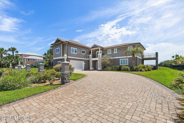 2481 S Ponte Vedra Blvd, Ponte Vedra Beach, FL 32082 - view of front of house featuring decorative driveway, an attached garage, and stucco siding