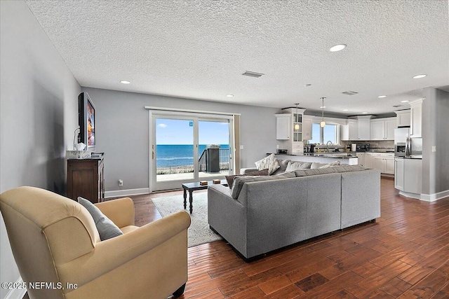 2481 S Ponte Vedra Blvd, Ponte Vedra Beach, FL 32082 - living area featuring dark wood-style floors, recessed lighting, and a textured ceiling
