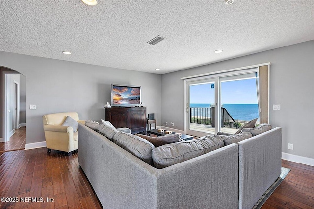 2481 S Ponte Vedra Blvd, Ponte Vedra Beach, FL 32082 - living area featuring arched walkways, dark wood-style floors, a textured ceiling, and recessed lighting