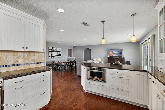 2481 S Ponte Vedra Blvd, Ponte Vedra Beach, FL 32082 - kitchen featuring arched walkways, decorative backsplash, recessed lighting, white cabinets, and dark wood finished floors