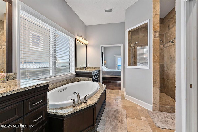 2481 S Ponte Vedra Blvd, Ponte Vedra Beach, FL 32082 - ensuite bathroom featuring a whirlpool tub, a walk in shower, stone tile floors, and vanity