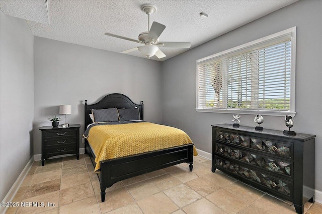 2481 S Ponte Vedra Blvd, Ponte Vedra Beach, FL 32082 - bedroom with light stone finish flooring, a textured ceiling, and a ceiling fan