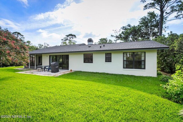 110 Abalone Ln W, Ponte Vedra Beach, FL 32082 - back of property featuring a patio area, stucco siding, a lawn, and a chimney