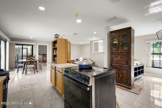 110 Abalone Ln W, Ponte Vedra Beach, FL 32082 - kitchen with black electric range oven, light marble finish floors, light countertops, a kitchen island, and recessed lighting