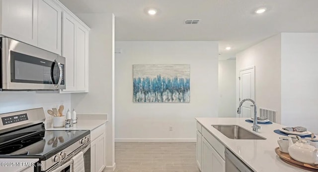 179 Charmer Trce, Saint Augustine, FL 32092 - kitchen with appliances with stainless steel finishes, recessed lighting, white cabinetry, light countertops, and light wood-style floors
