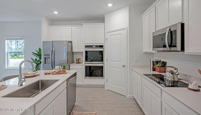 179 Charmer Trce, Saint Augustine, FL 32092 - kitchen with appliances with stainless steel finishes, white cabinets, light countertops, and recessed lighting