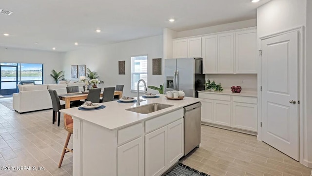 179 Charmer Trce, Saint Augustine, FL 32092 - kitchen with stainless steel appliances, open floor plan, light wood-type flooring, white cabinets, and recessed lighting